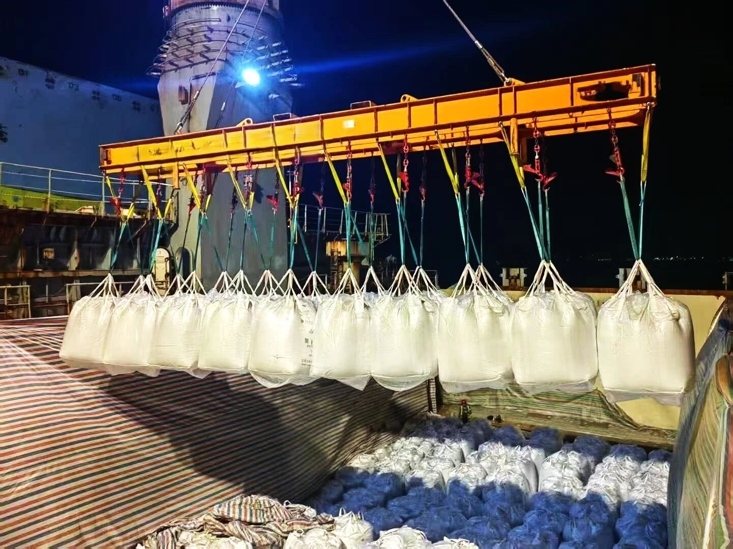 A crane lifting bulk bags