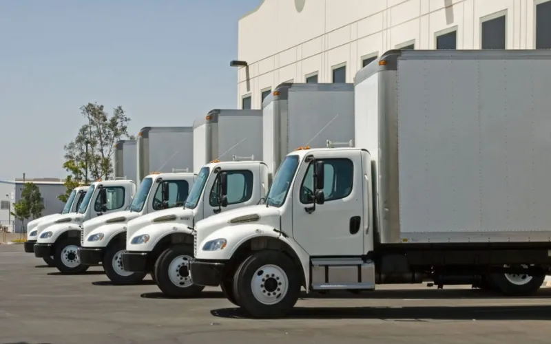 Box trucks lined up at a warehouse