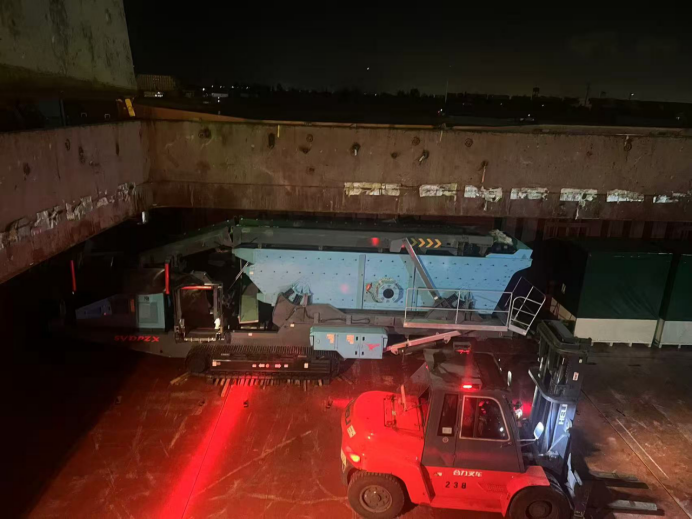 Mining equipment being loaded at night