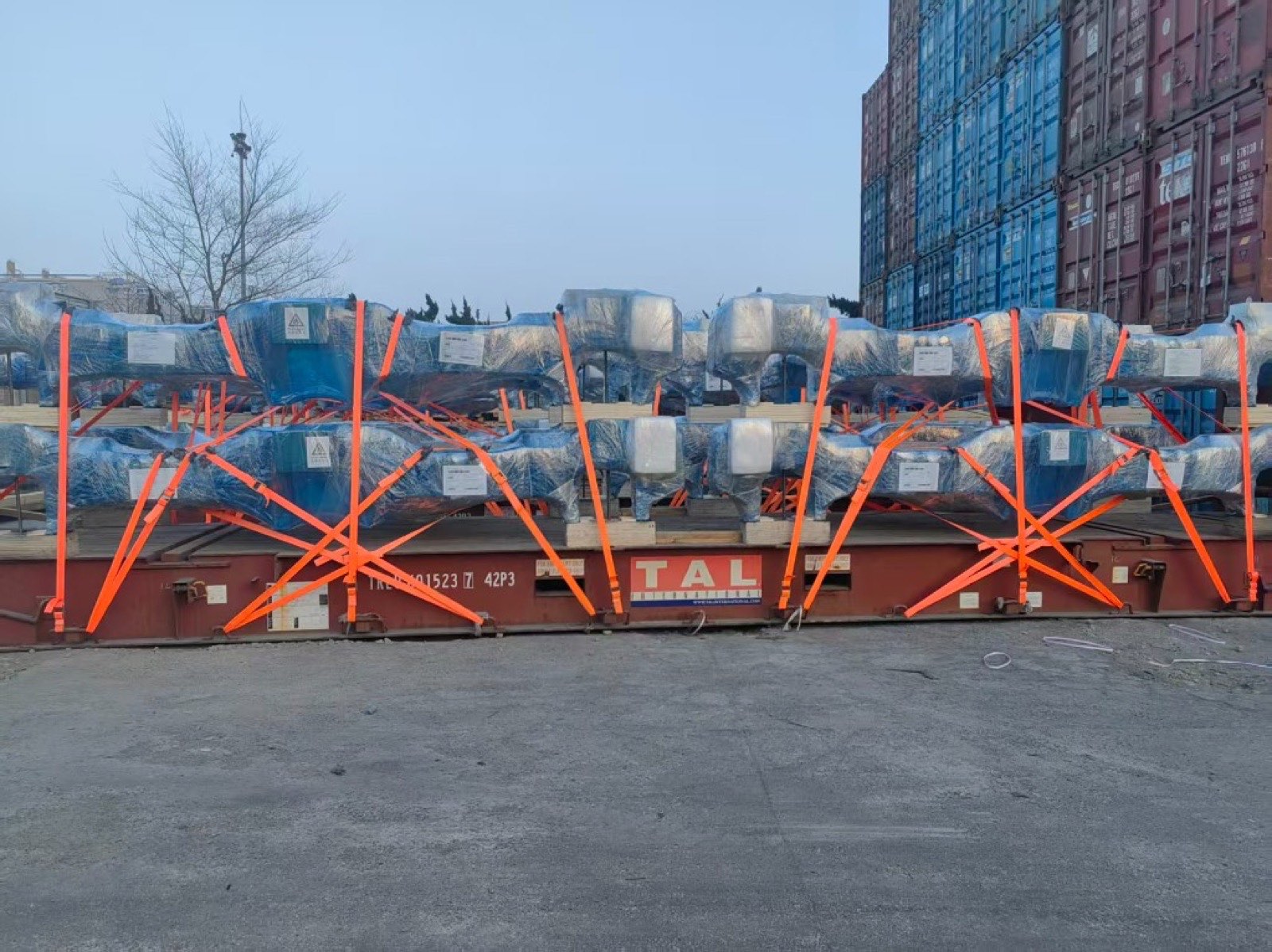 Machinery lashed with straps on a flat rack