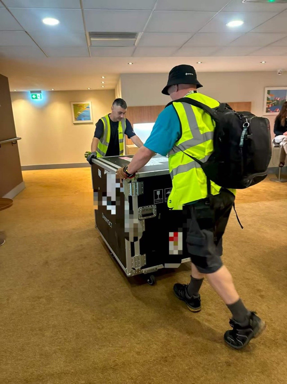 A flight case wheeled into a venue